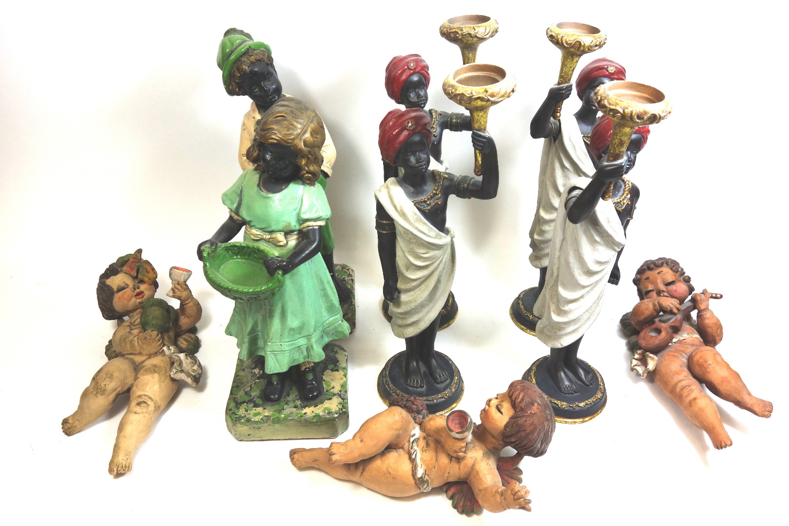 Appraisal: A set of four reproduction blackamoor figures cm high and