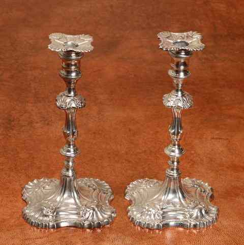 Appraisal: A PAIR OF GEORGE III SILVER CAST CANDLESTICKS standing on