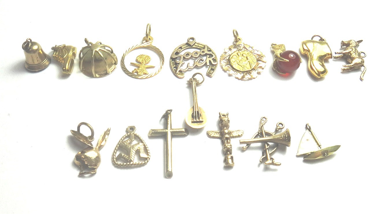 Appraisal: A group of sixteen mostly ct gold pendants and charms