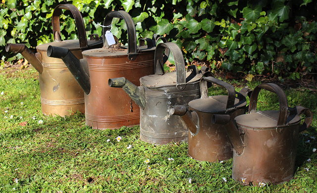 Appraisal: FIVE ANTIQUE COPPER WATER CANS of oval form with a