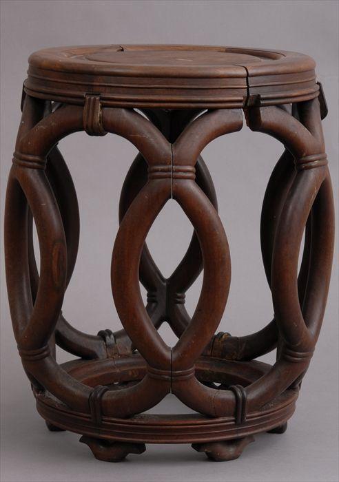 Appraisal: CHINESE HARDWOOD BARREL-FORM STOOL The seat with burrwood panel on