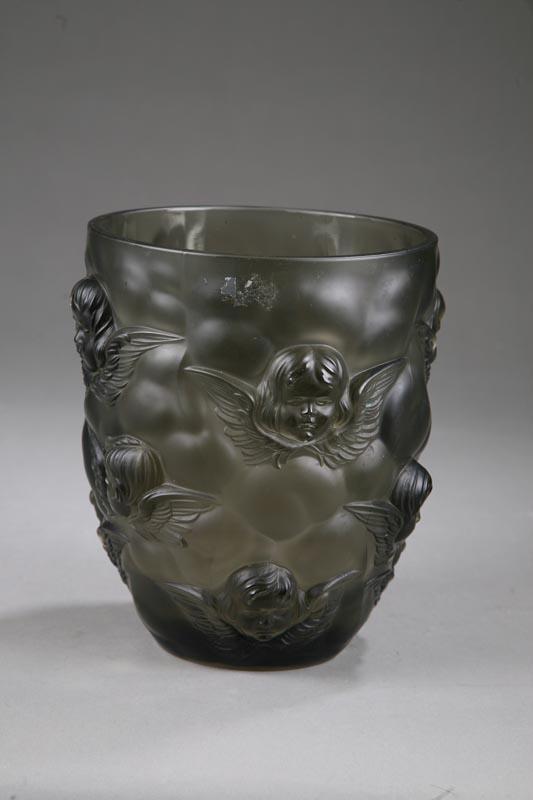 Appraisal: SMOKEY COLORED GLASS VASE With molded cupids heads and wings