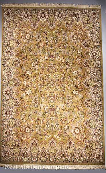 Appraisal: A Persian Carpet olive ground with repeating floral motifs ft