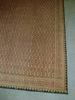 Appraisal: An Oriental style carpet with multiple borders upon a salmon