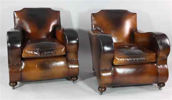 Appraisal: A pair of early th century tan leather club chairs