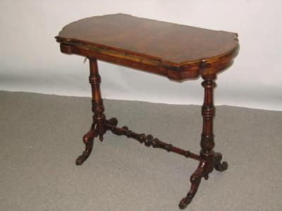 Appraisal: A VICTORIAN WALNUT FOLDING CARD TABLE of canted oblong form