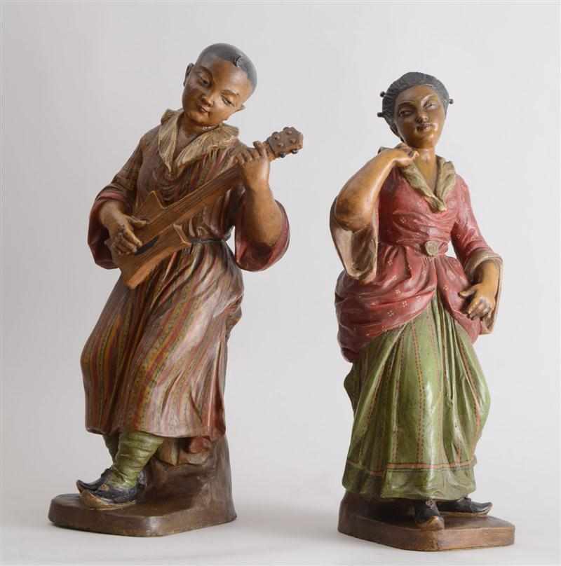 Appraisal: PAIR OF CHINOISERIE PAINTED TERRACOTTA FIGURES Modeled as a male