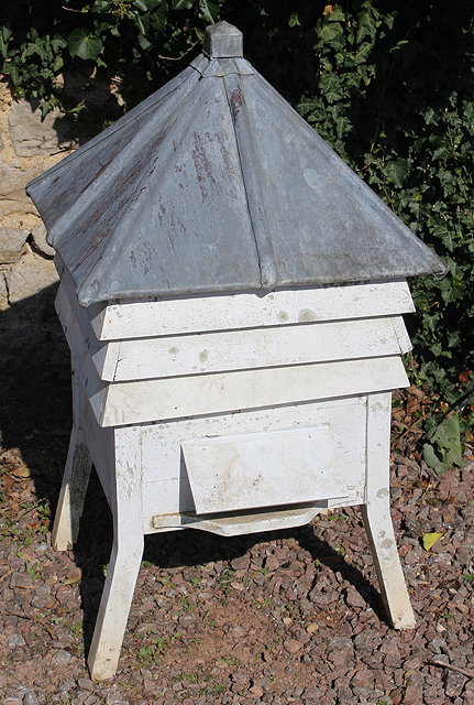 Appraisal: A WHITE PAINTED SECTIONAL BEEHIVE with leaded square pitched roof