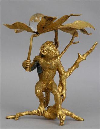 Appraisal: AUSTRIAN GILT-BRONZE MONKEY-FORM CENTERPIECE Modeled crouching by a tree stump