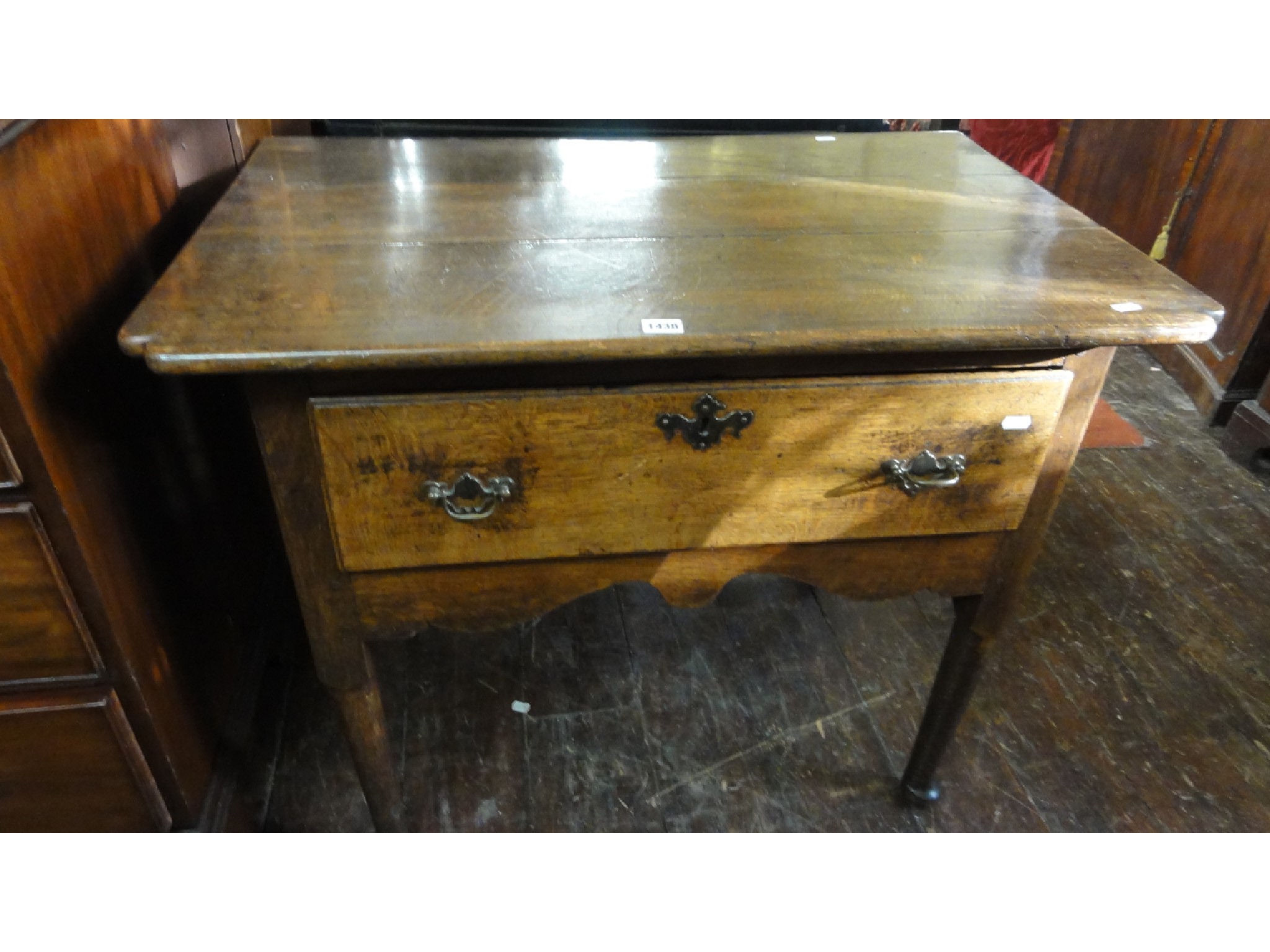 Appraisal: A Georgian oak country made side table fitted with a