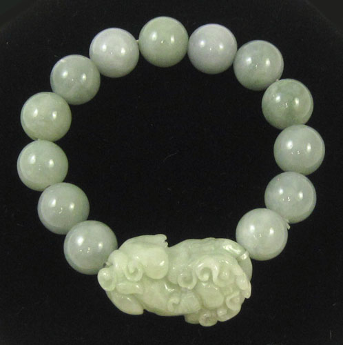 Appraisal: CHINESE GREEN JADE BEADED BRACELET strung with round light green