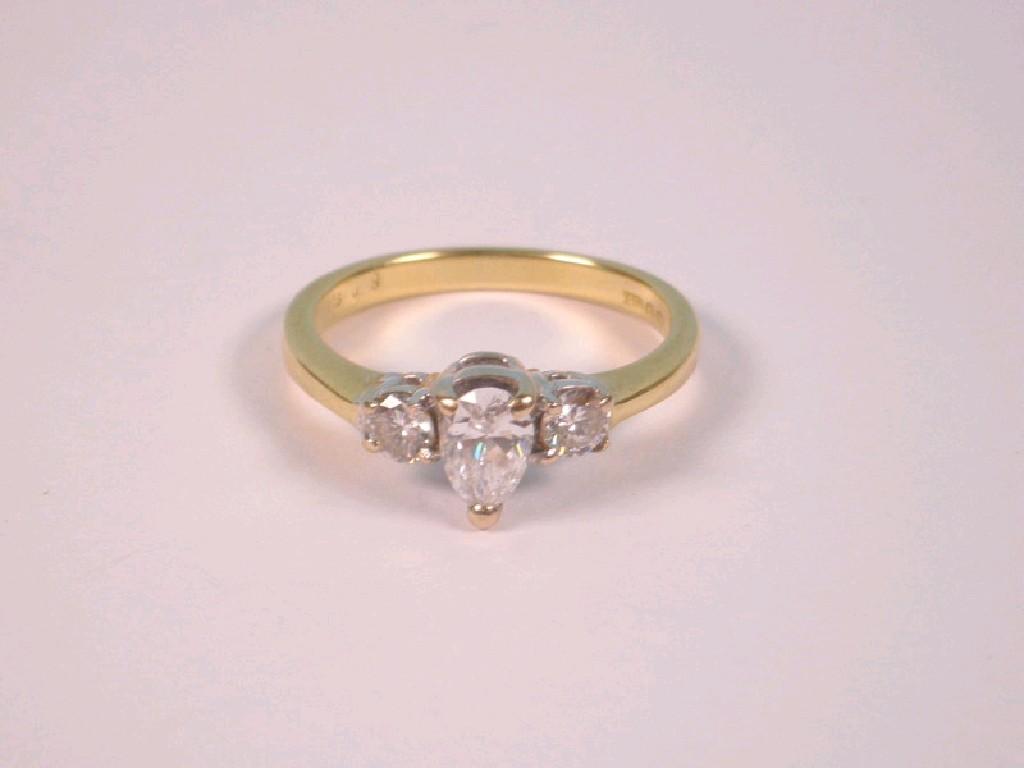 Appraisal: A three stone diamond ring a central tear drop shaped