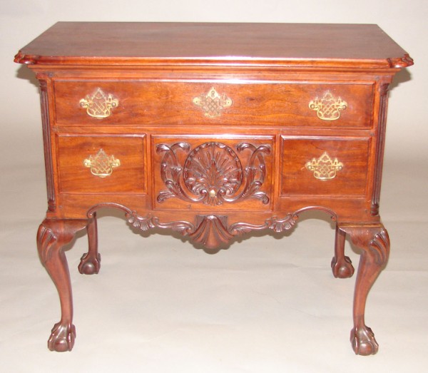 Appraisal: Mahogany shaped top four drawer base shell carved center drawer