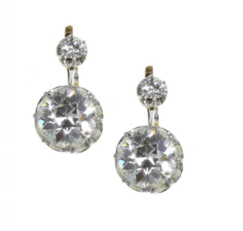 Appraisal: A PAIR OF DIAMOND EARRINGS with one larger articulated and