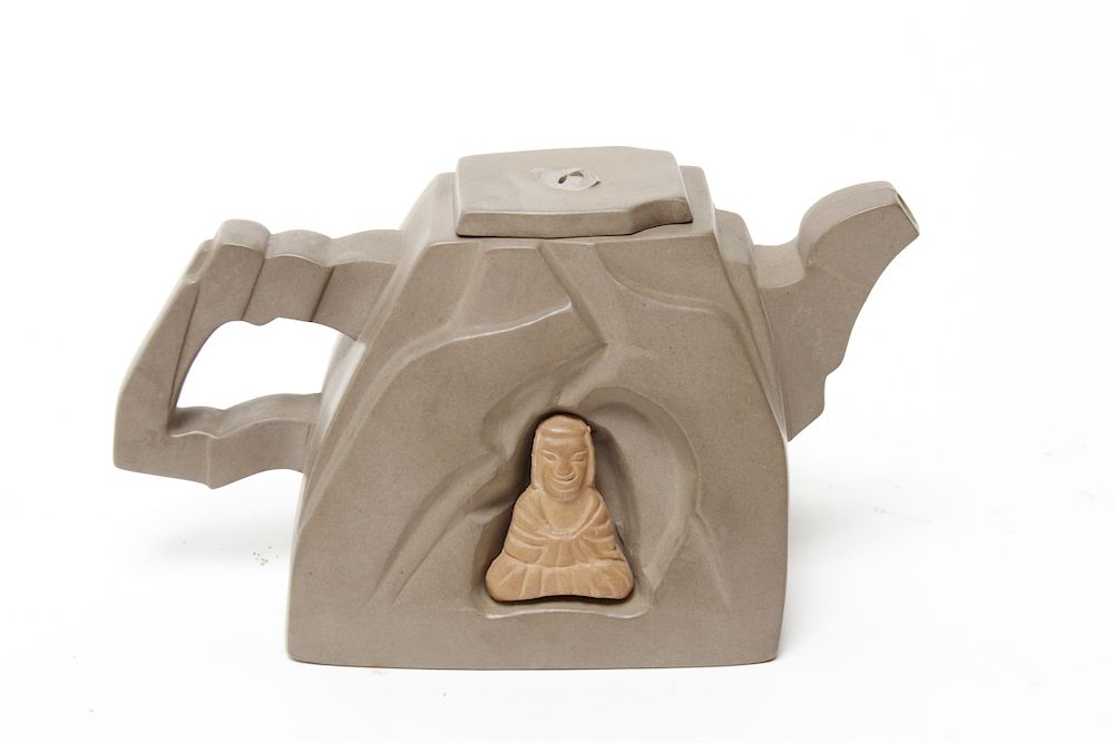 Appraisal: Chinese Yixing Teapot with Inset Cave Buddhas Chinese Yixing shaped