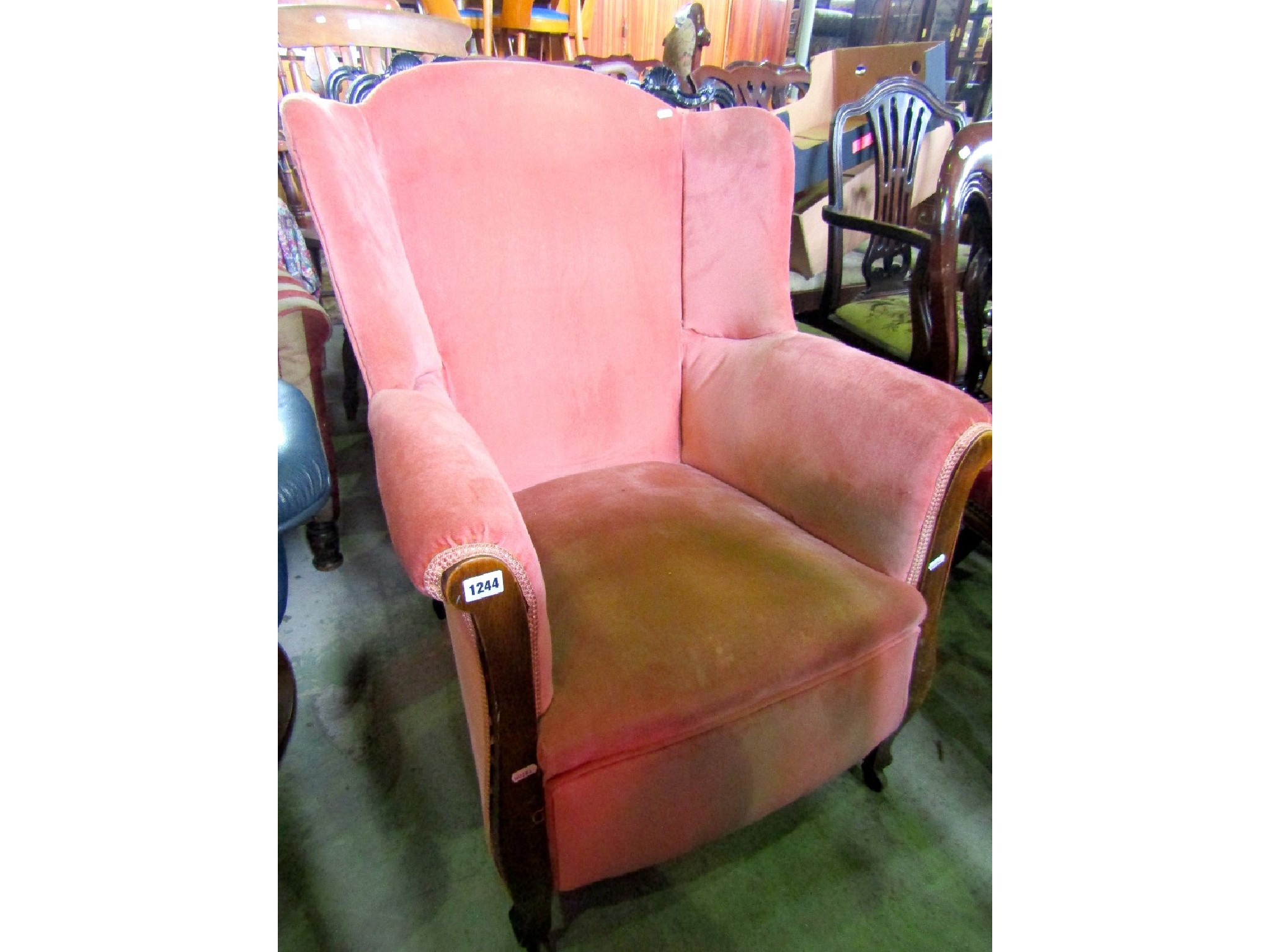 Appraisal: An Edwardian armchair with winged back pink dralon upholstered finish