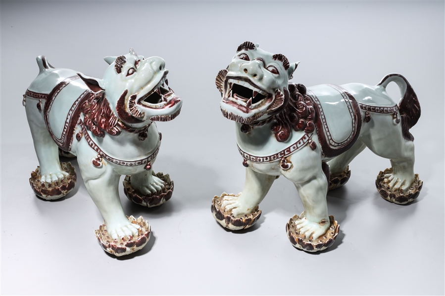 Appraisal: Two Chinese glazed porcelain lions x x each approx