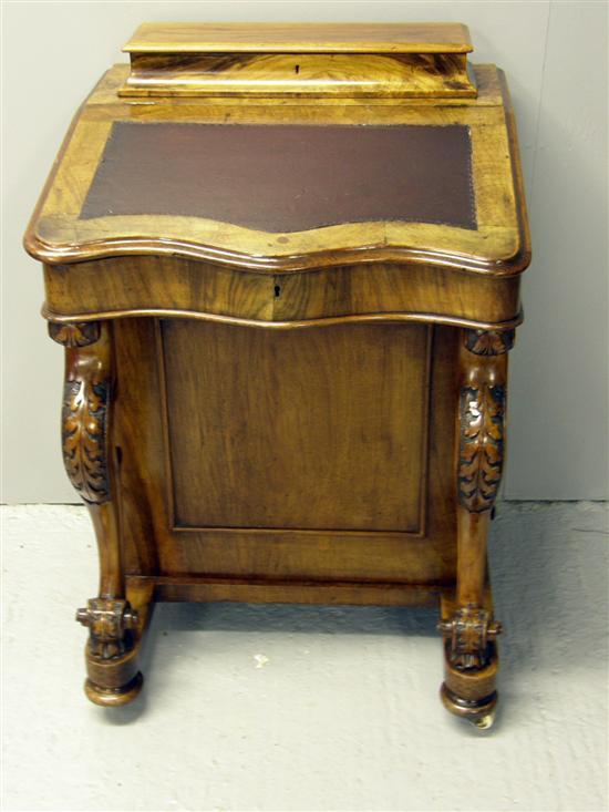 Appraisal: Victorian walnut Davenport with stationery compartment over sloping serpentine top