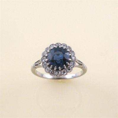 Appraisal: A sapphire and diamond cluster ring the circular cut sapphire