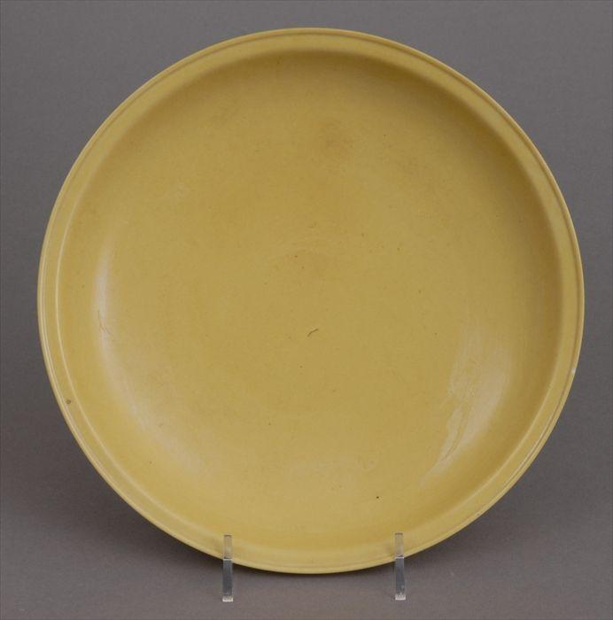 Appraisal: CHINESE YELLOW-GLAZED FOOTED DISH The shallow bowl with everted rim