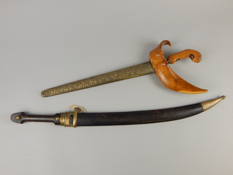 Appraisal: Two Eastern short swords or daggers a Malayan kris and