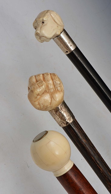 Appraisal: AN IVORY HANDLED STICK the handle carved in the form