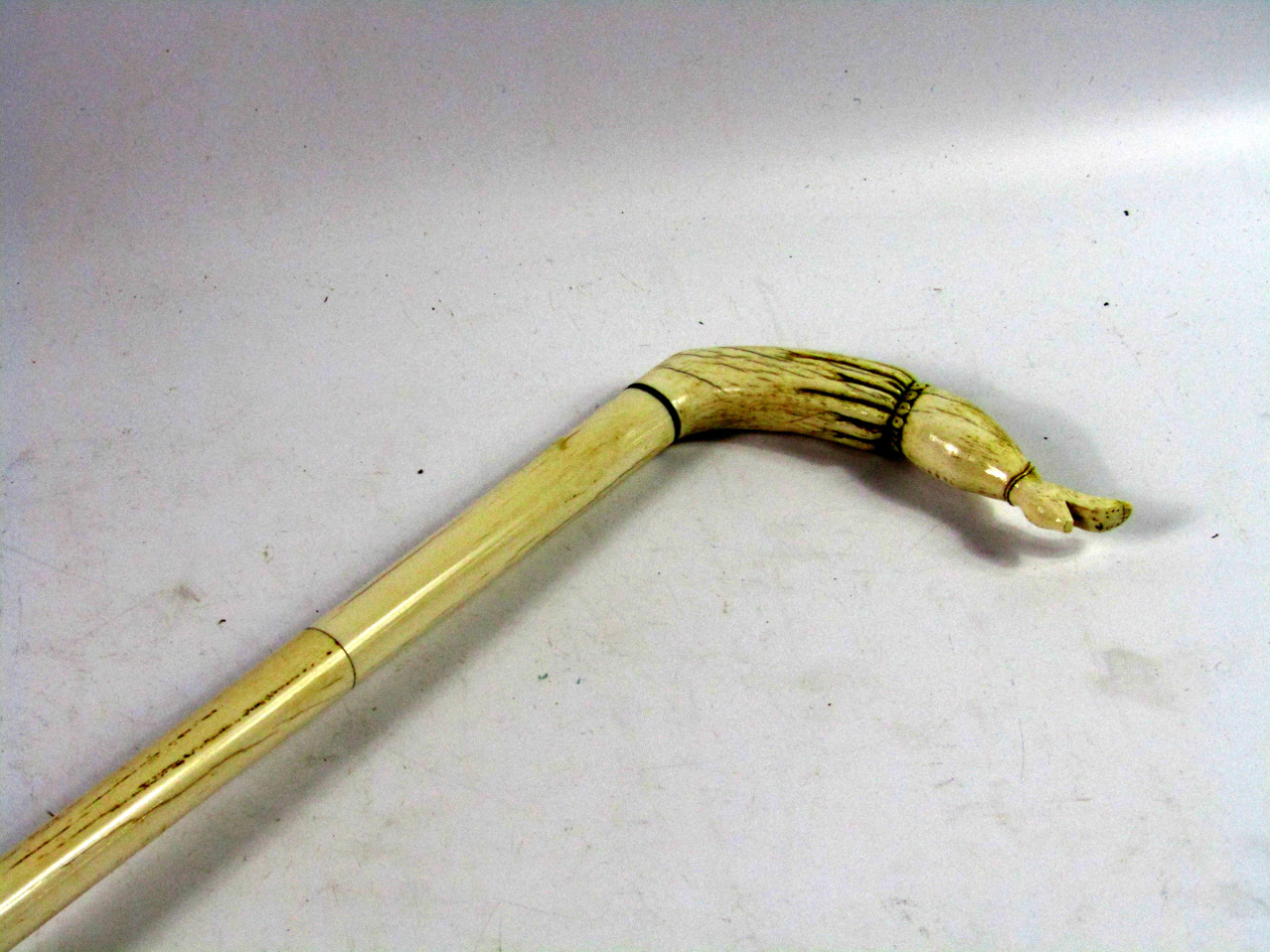 Appraisal: A Victorian ivory walking stick carved to the handle as