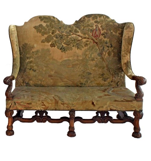 Appraisal: A th Century walnut twin arch top wing back sofa