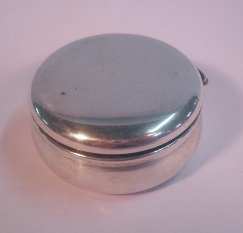 Appraisal: An Edward VII silver pill box of plain circular cushion