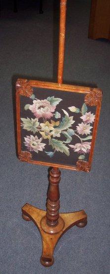 Appraisal: A Victorian mahogany pole screen with needlework screen and triform