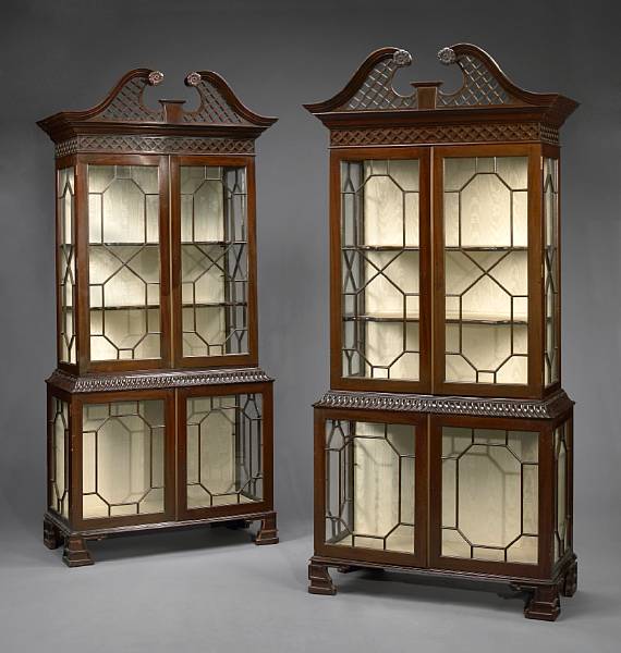 Appraisal: A pair of George III style carved mahogany display cabinets