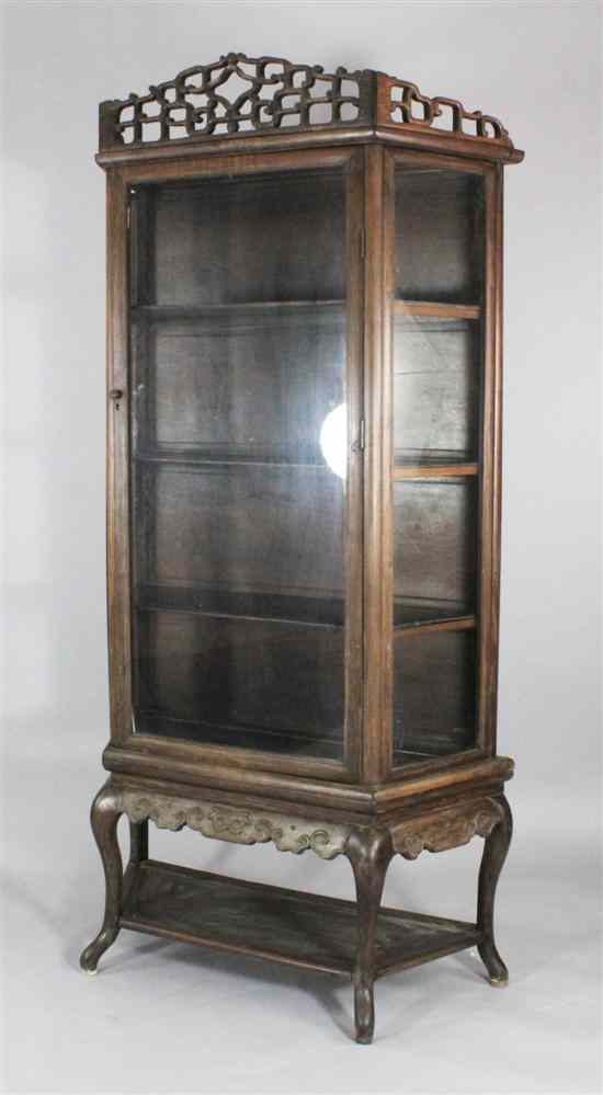 Appraisal: A late th century Chinese hardwood display cabinet with single