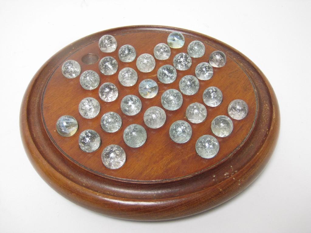 Appraisal: A mahogany Solitaire Board with clear glass marbles