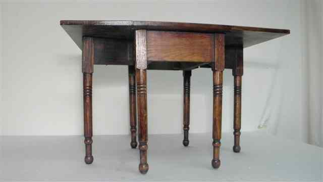 Appraisal: Child's mahogany drop leaf table Legs fold out to support