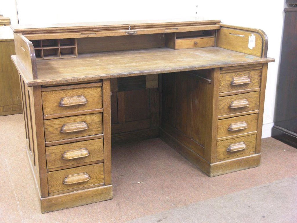 Appraisal: An early th century solid oak-roll top desk tambour shutter