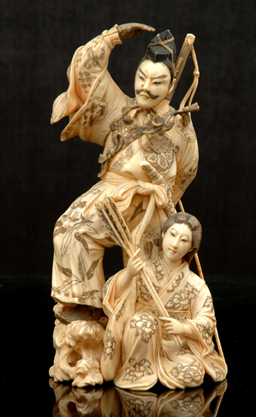 Appraisal: A JAPANESE IVORY OKIMONO OF AN ARCHER AND ATTENDANT Meiji