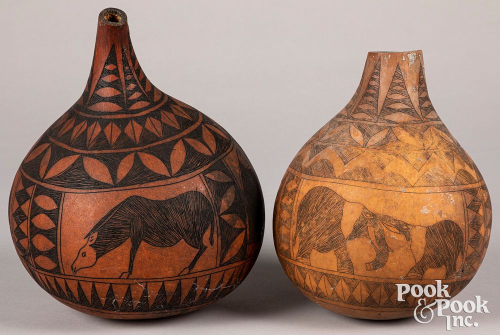 Appraisal: Two African decorated gourd bottle Two African decorated gourd bottle