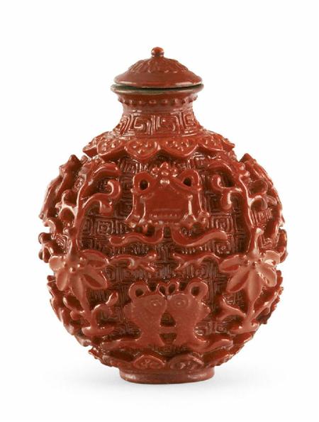 Appraisal: A Chinese moulded porcelain snuff bottle with coral glaze -