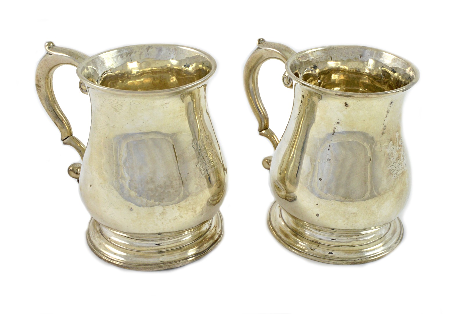 Appraisal: A pair of George II silver pear shape mugs Thomas