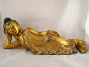 Appraisal: A well carved wood reclining Buddha covered in gold leaf