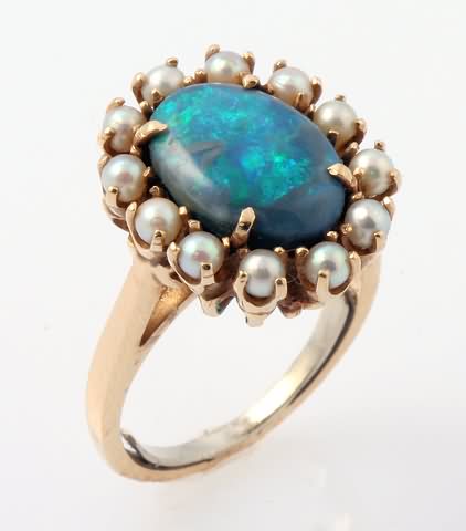 Appraisal: KY X mm oval black opal surrounded by mm round