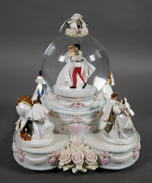 Appraisal: Musical and animated snow globe showing Disney princesses in wedding