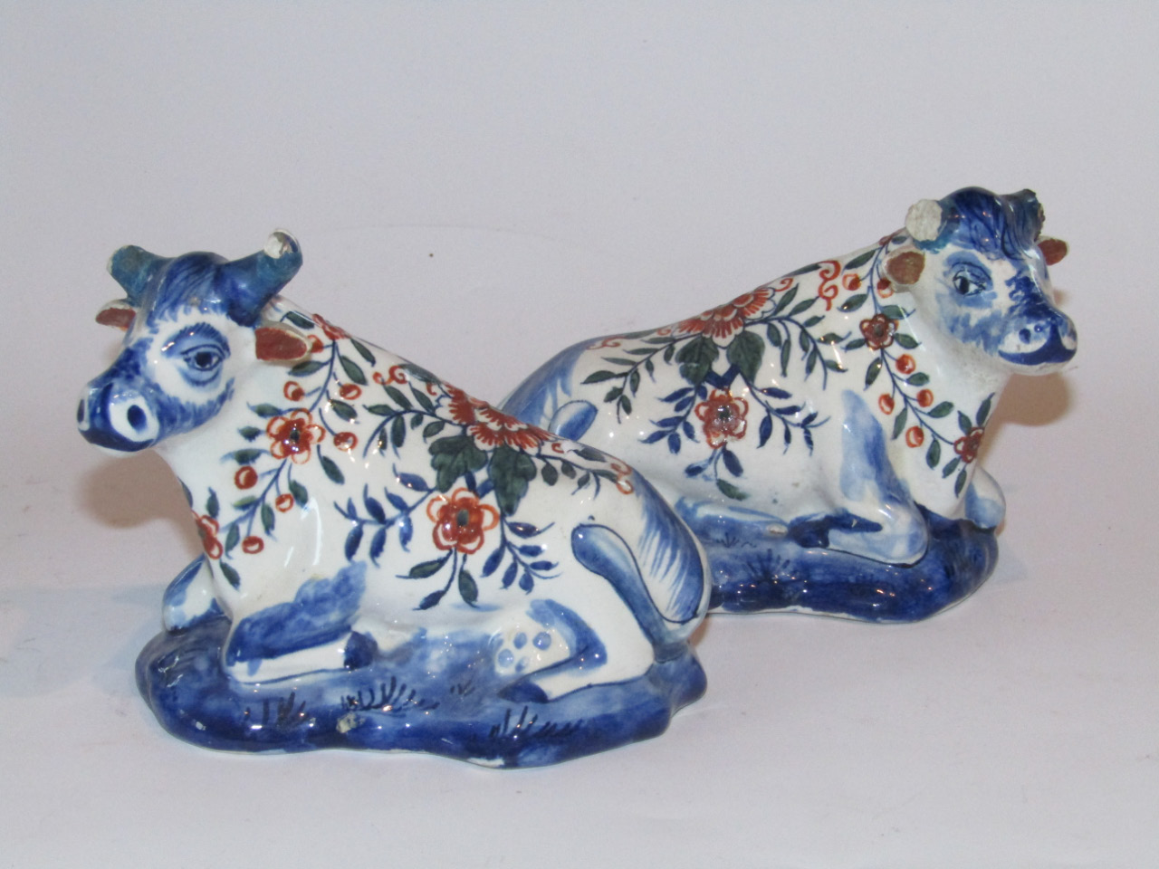 Appraisal: A pair of Dutch Delft tin glazed earthenware figures of