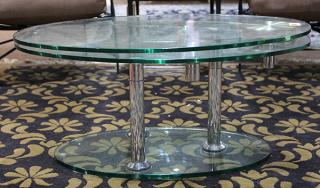 Appraisal: Moderne tiered oval glass coffee table the two plate glass