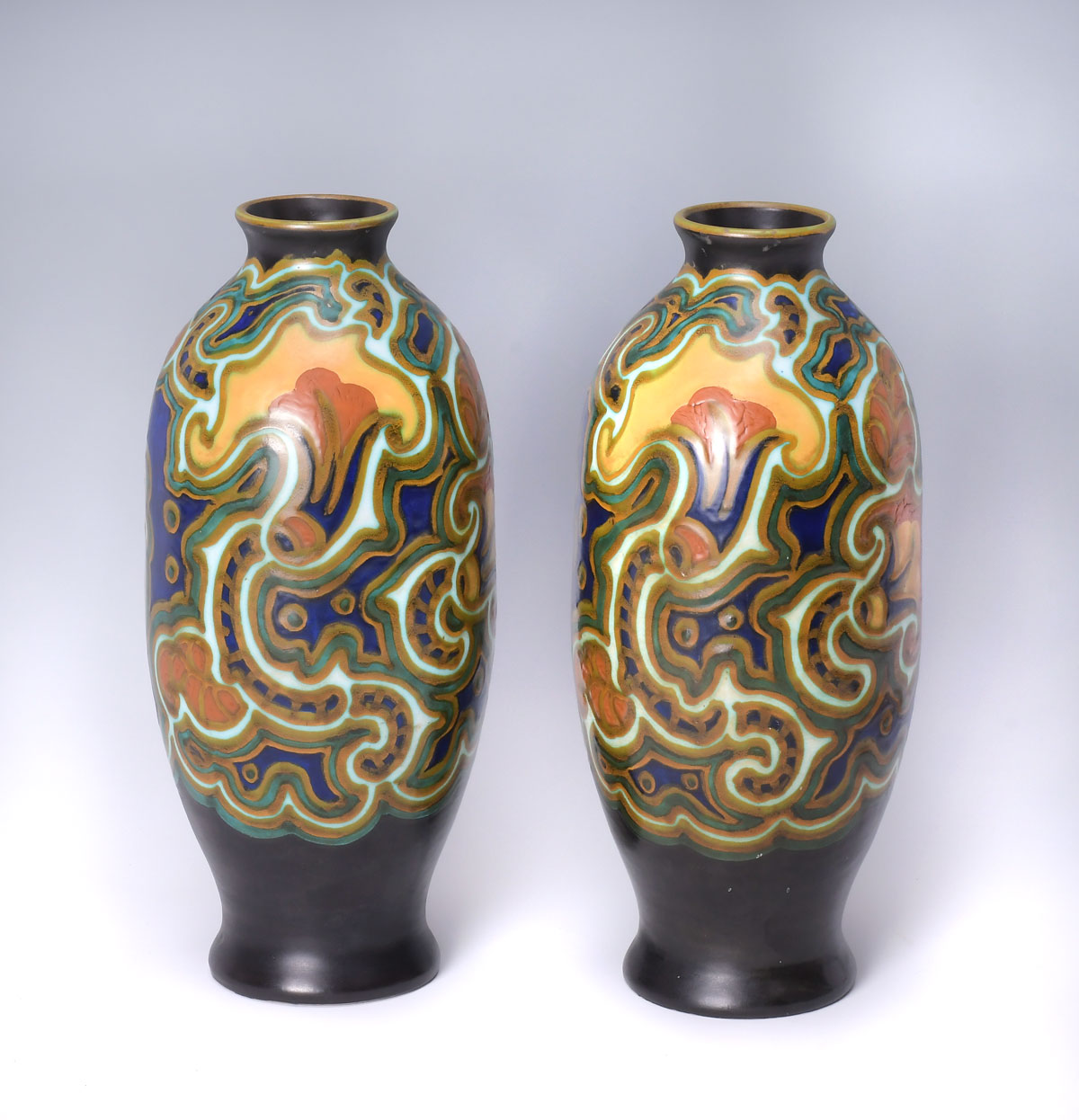 Appraisal: PAIR GOUDA CERAMIC ART NOUVEAU VASES Polychromed art nouveau stylized