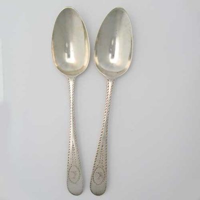 Appraisal: A pair of George III Irish bright-cut tablespoons crested by