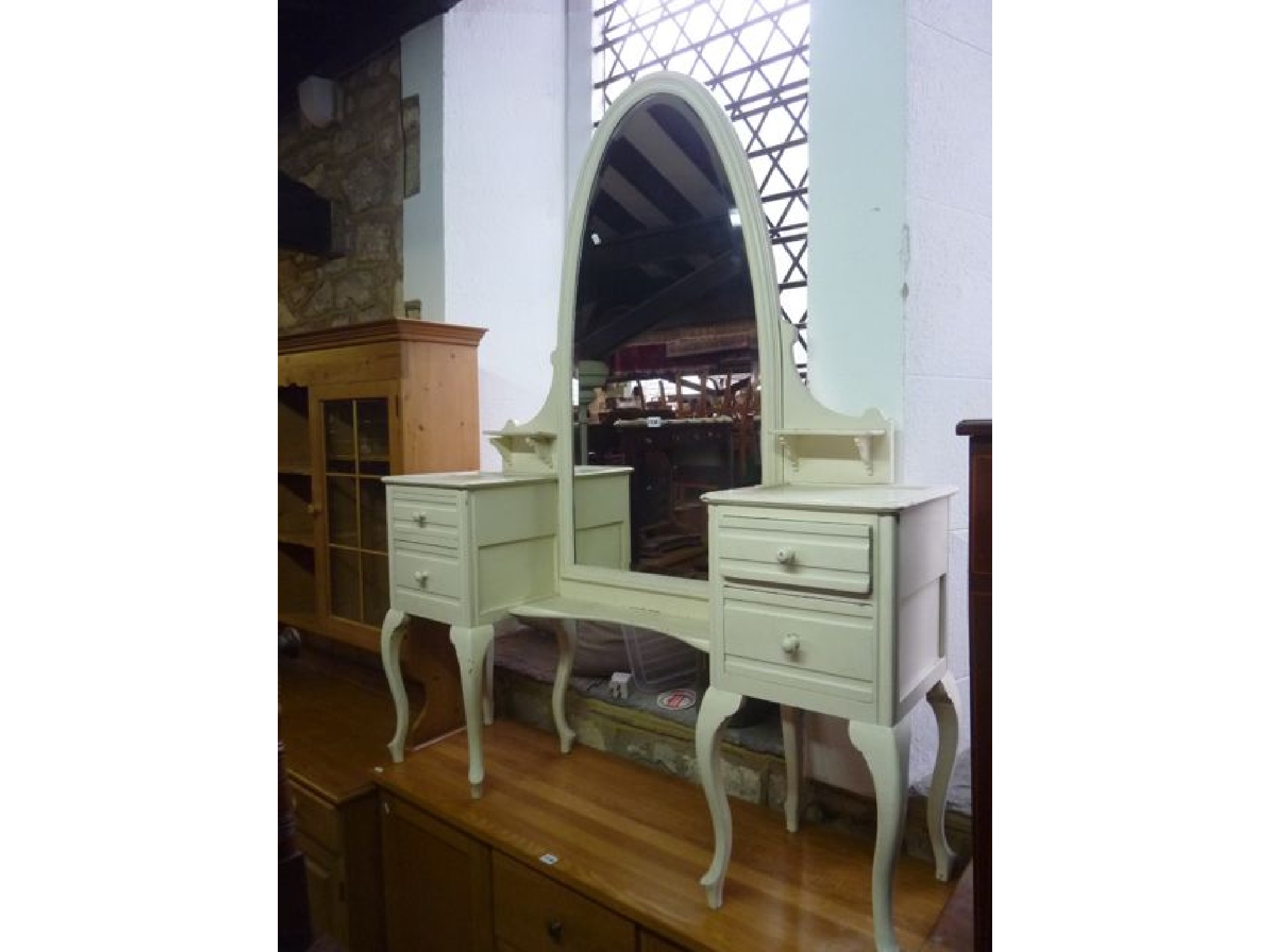 Appraisal: An unusual painted dressing table the central arched bevelled edge