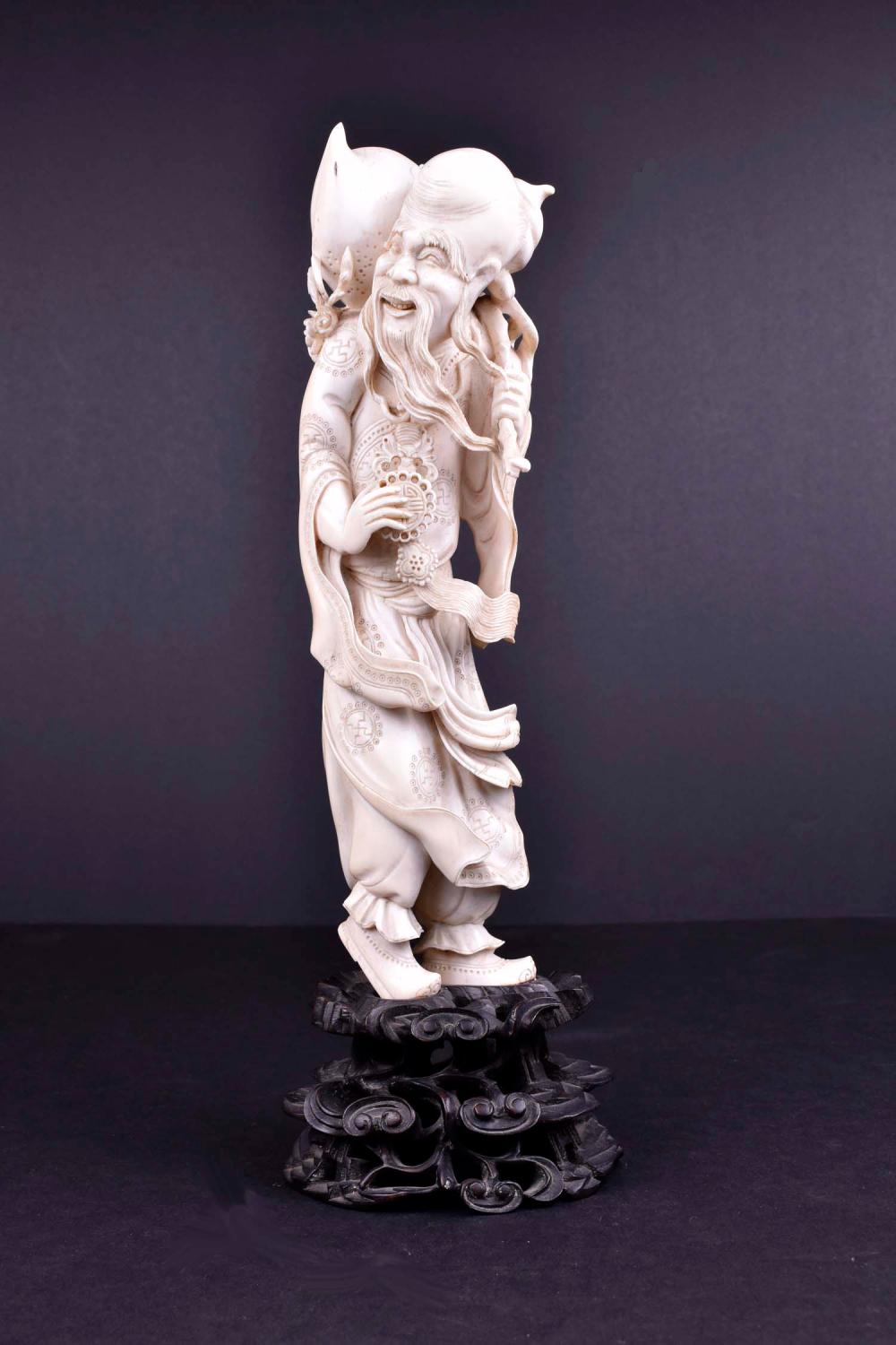 Appraisal: CHINESE CARVED FIGURE OF SHOU LAOThe standing deity dressed in