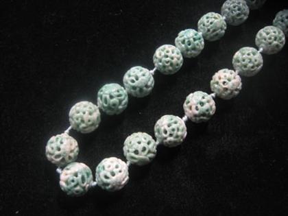 Appraisal: Jade necklace Twenty-five carved jade circular pieces on matching knotted