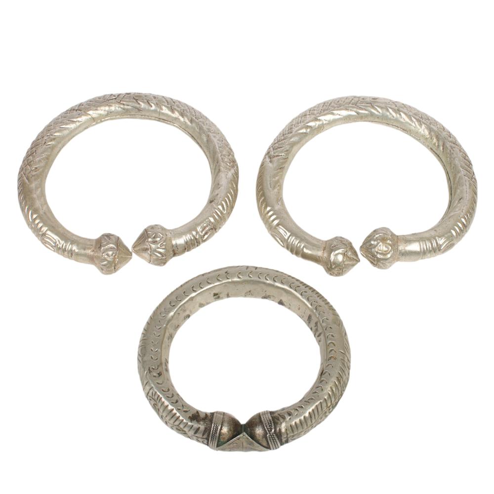 Appraisal: COLLECTION OF THREE NEAR EASTERN SILVER TRIBAL CURRENCY BANGLE BRACELETS